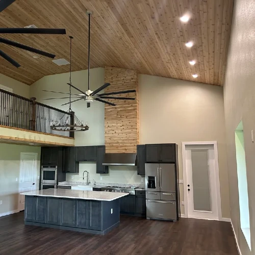 Barndominium interior with vaulted ceilings and open kitchen