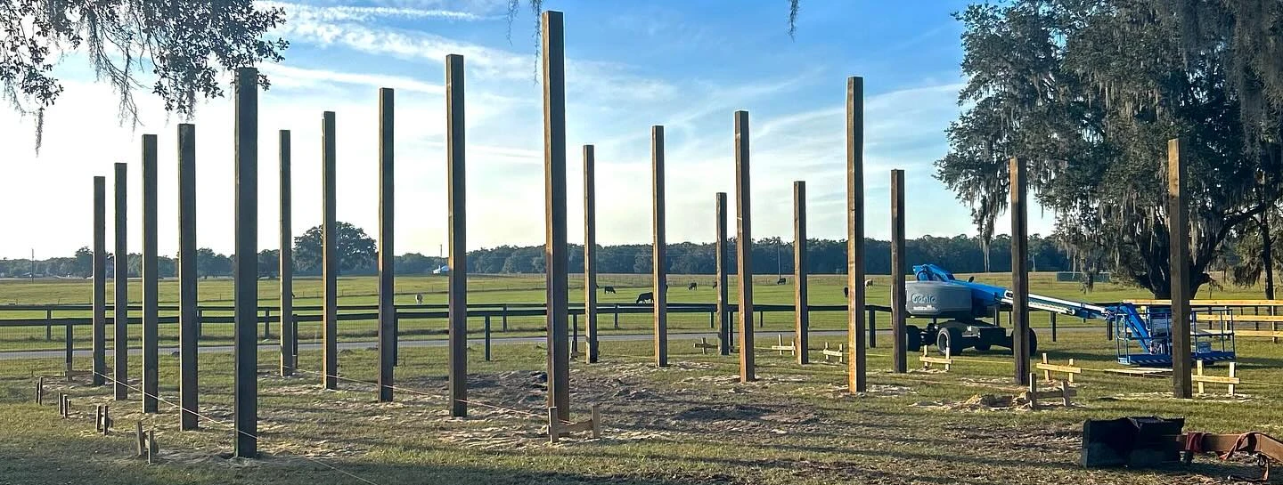Treated posts set in the ground for a pole barn home in Central Florida