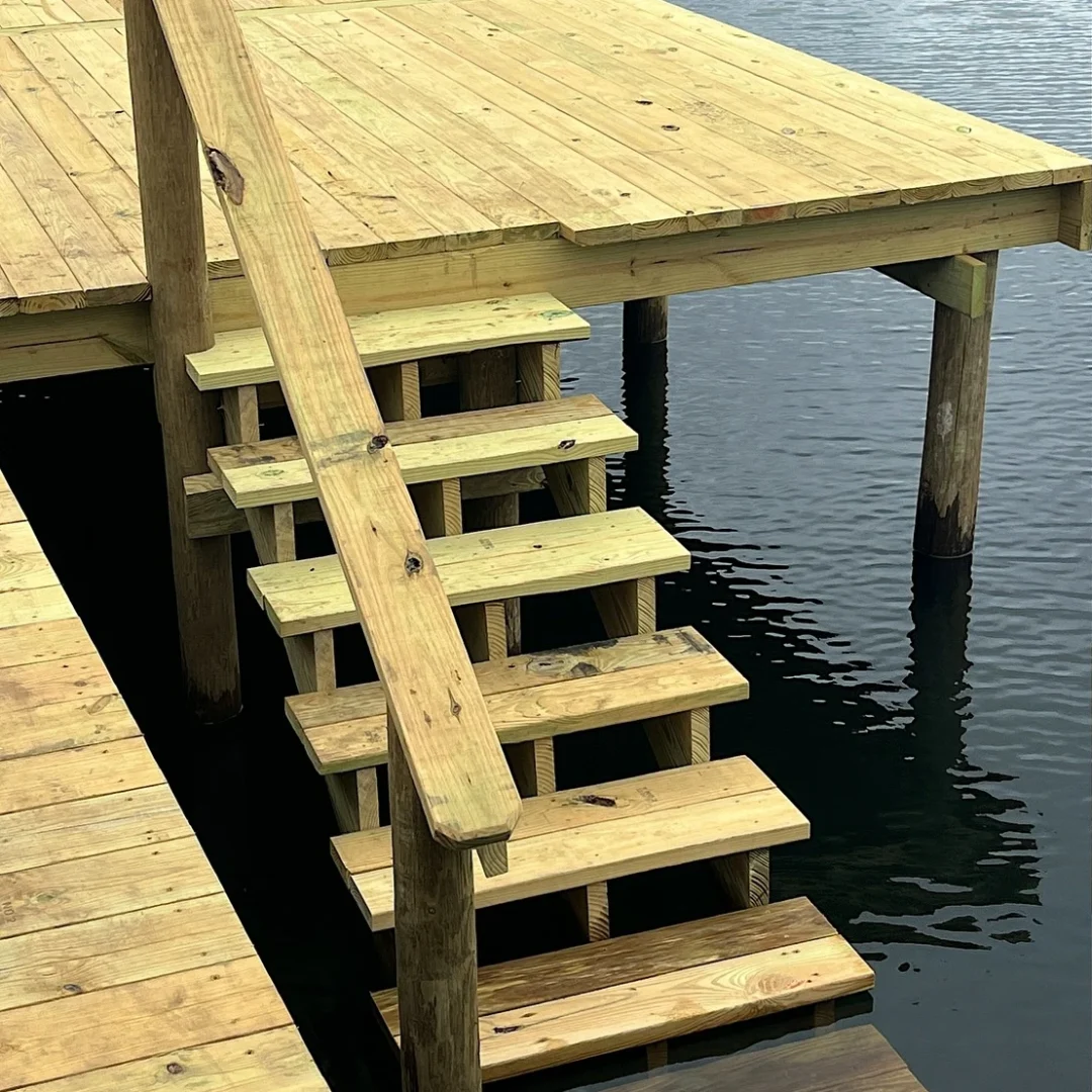 New pressure-treated decking and stairs installed on a Central Florida dock by JSC Contracting