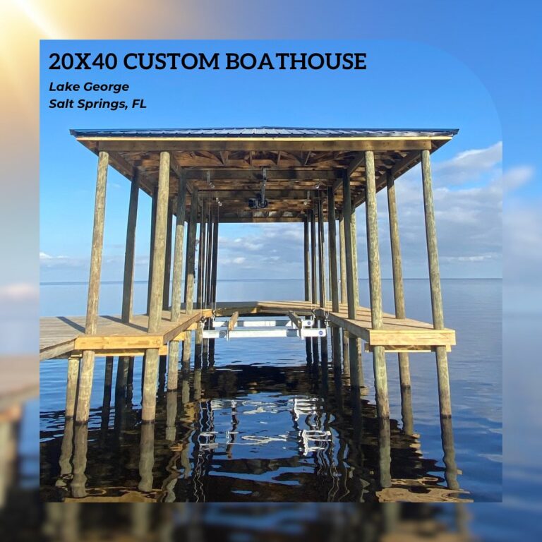 Wooden boathouse frame on pilings over a calm lake; text reads '20X40 CUSTOM BOATHOUSE' and 'Lake George, Salt Springs, FL'.